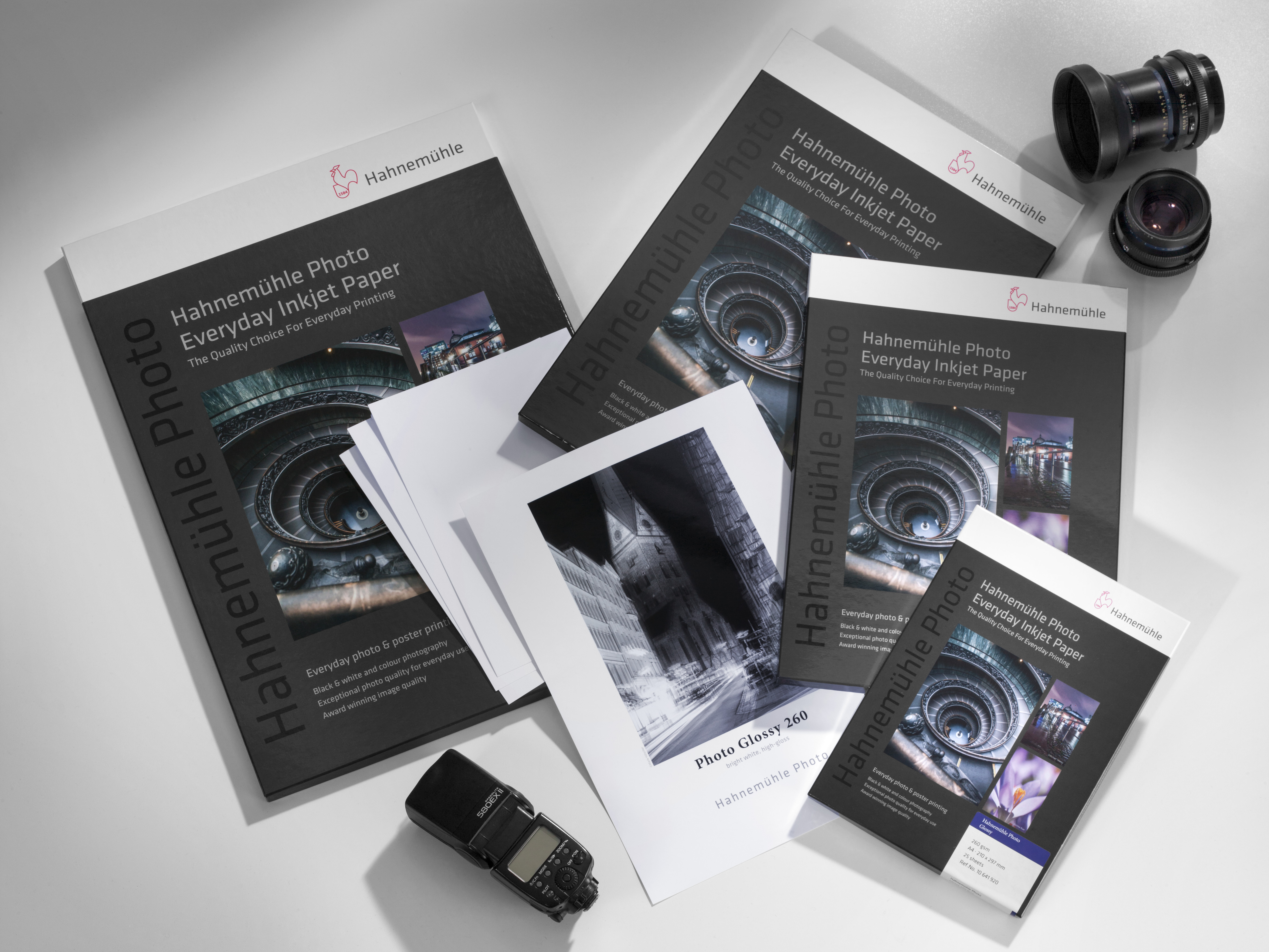 Mood-Photo Glossy 260 Photo Glossy 260 products are on the floor with cameras and printed papers.