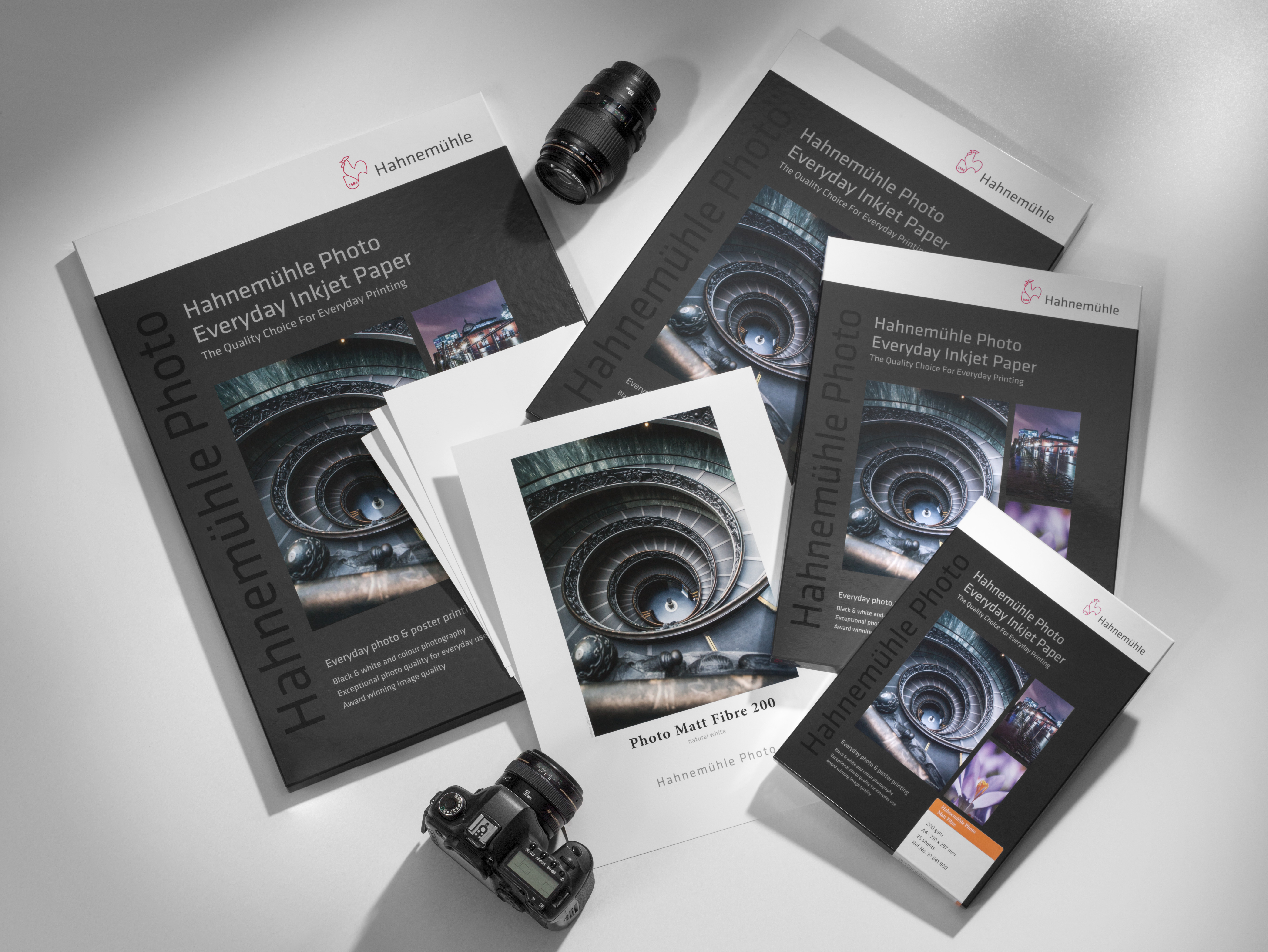 Mood-Photo-Matt -Fibre-200 Photo Matt Fibre 200 products lie on the floor with cameras and printed papers.