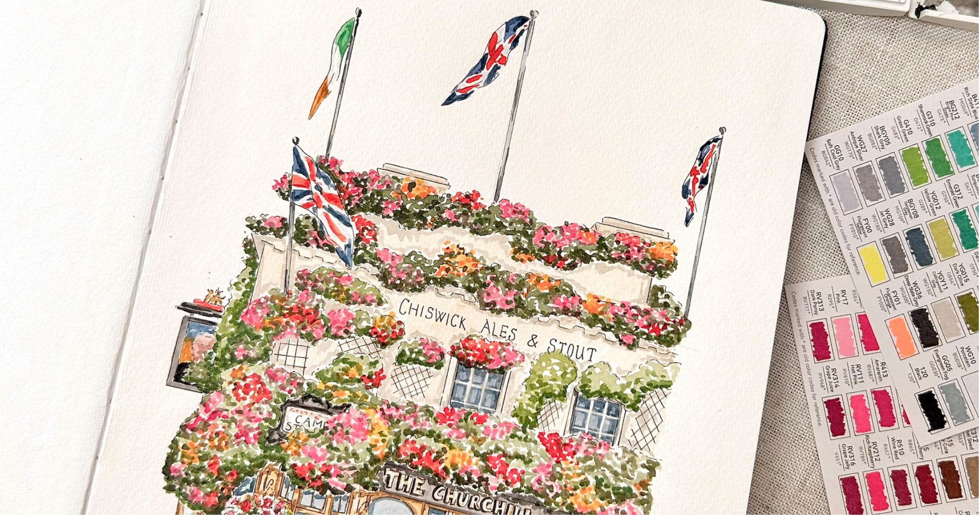 flowering balcony, floral display, building facade, flag poles, street sign