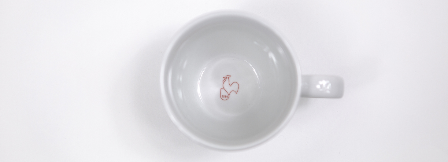 Hahnemühle porcelain mug with logo red rooster